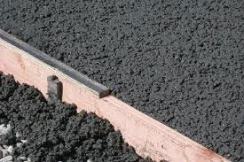 Paving Contractors Tampa image of asphalt being formed on ground.