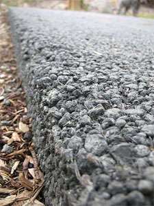 Paving Contractor Tampa flattening freshly poured asphalt.