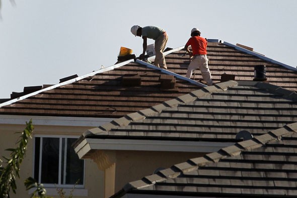 Roofers in Tampa installing a mexican tile roof.